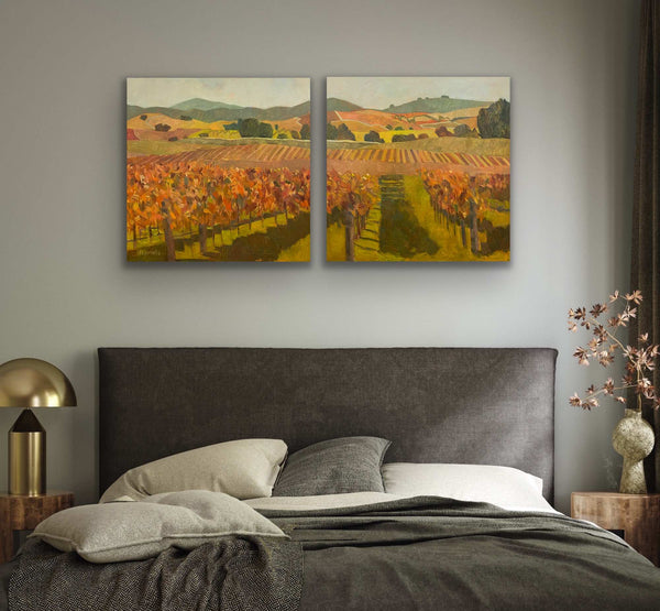 Vineyard landscape oil paintings above a bed. 