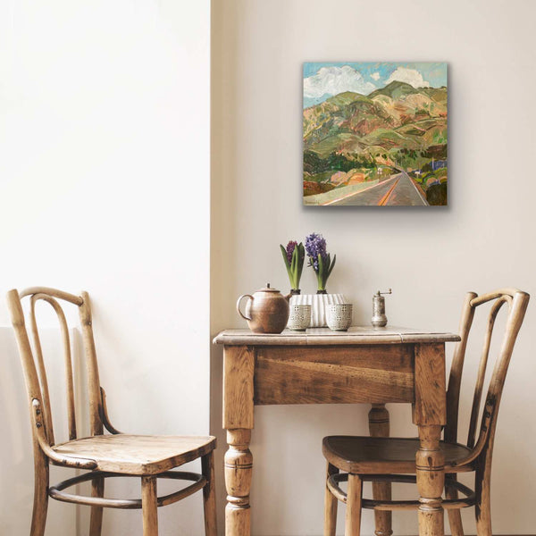 Breakfast table with oil painting of Big Sur