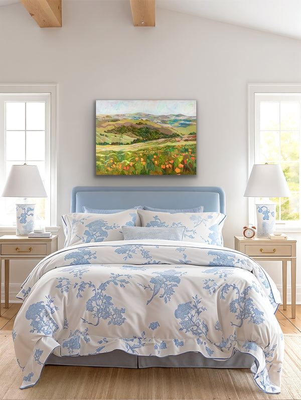 Bedroom with floral bedding, nightstands, and a landscape painting on the wall.