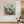 Colorful abstract painting in a modern living room with a gray sofa and plant.