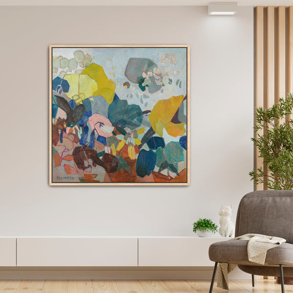 Colorful abstract painting in a modern living room with a gray sofa and plant.