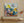 Abstract painting on a wall above a wooden shelf with decorative items.