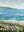 Artistic depiction of a coastal scene featuring a large body of water and mountains.