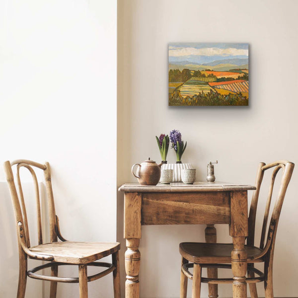 Vineyard painting above table and chairs