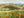 Painting of a landscape with rolling hills and fields.